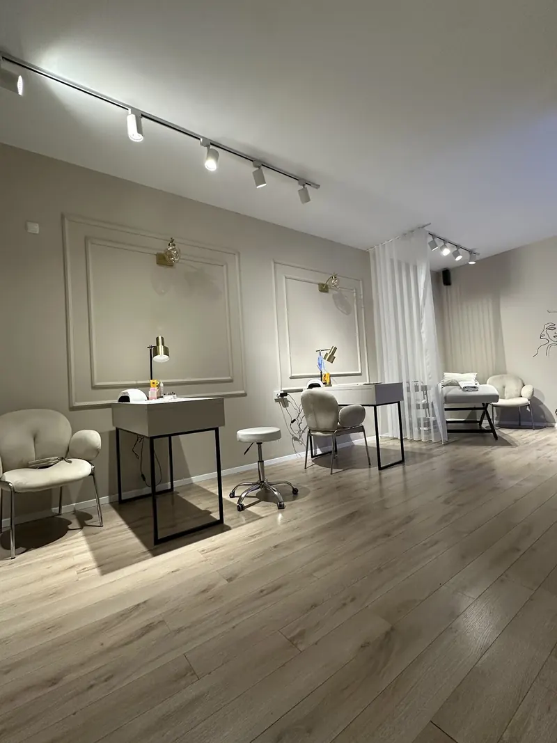 Bright salon floor with manicure tables and soft chairs