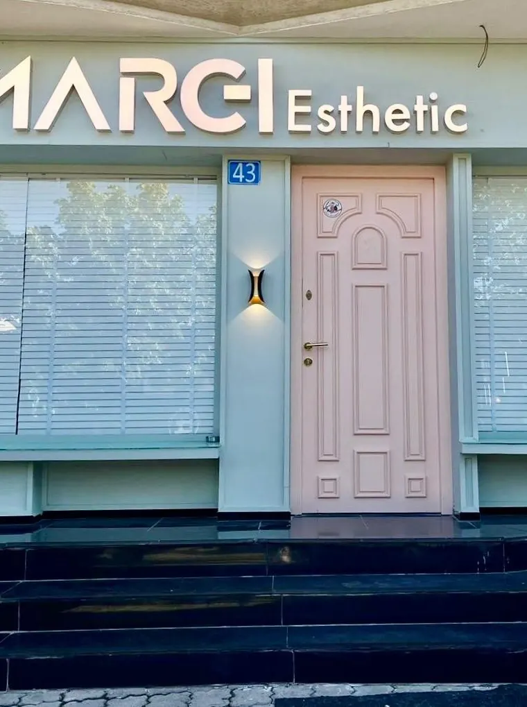 Studio entrance with a pale pink door under the Marei Esthetic sign