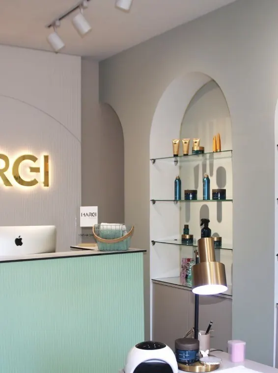 Reception desk beside arched shelves of polishes and care products