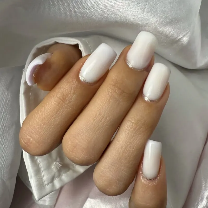 Long milky-white square nails on satin
